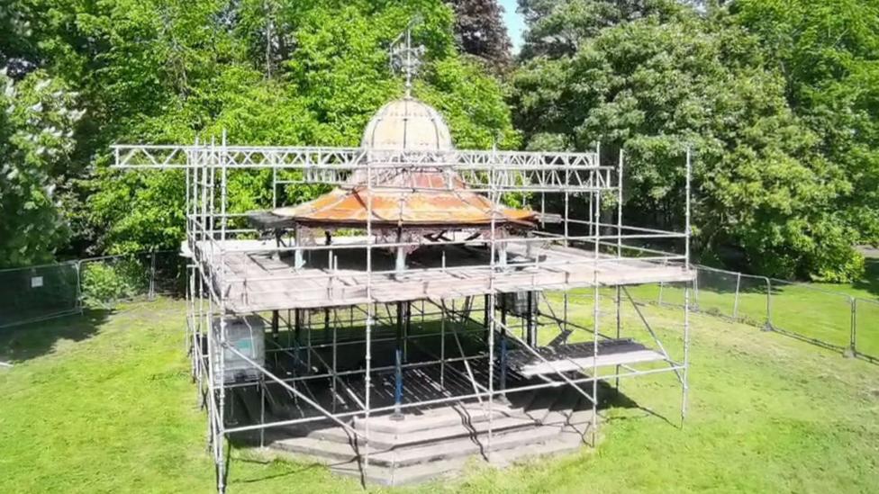 A bandstand covered in scaffolding
